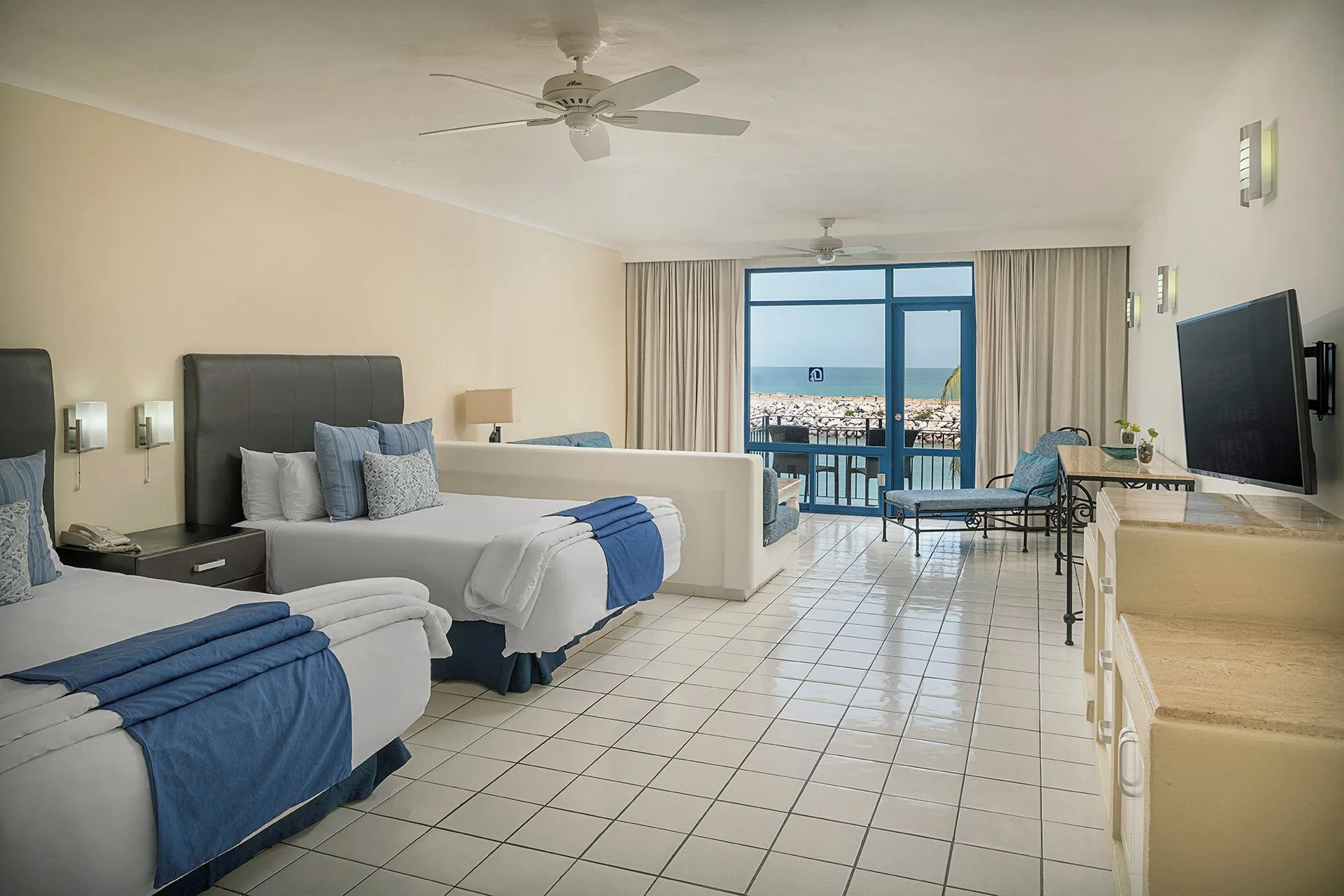 Junior Suite with two beds and balcony marina view at El Cid Marina Beach Hotel.