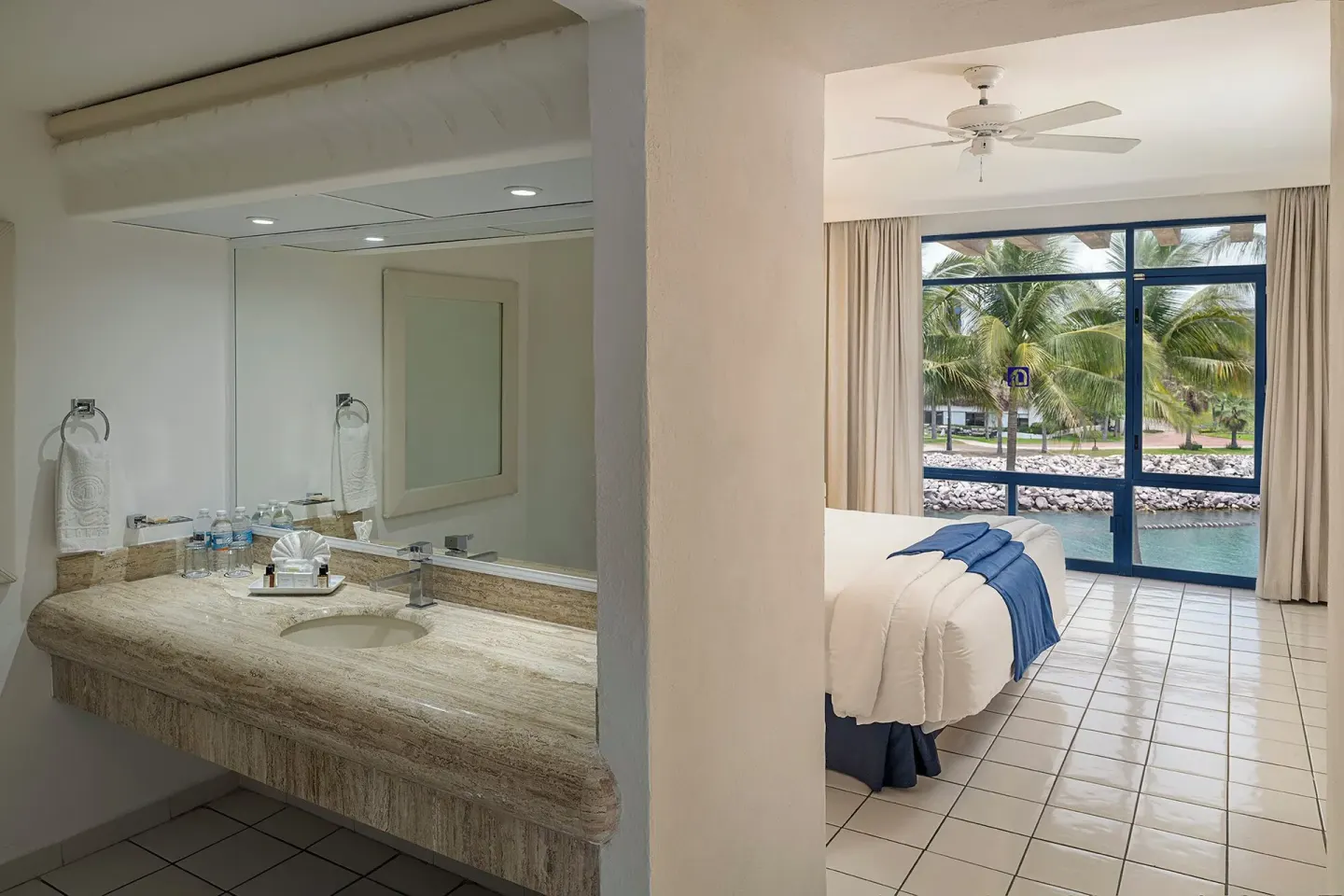 One Bedroom Suite bathroom vanity beside bedroom at El Cid Marina Beach Hotel.