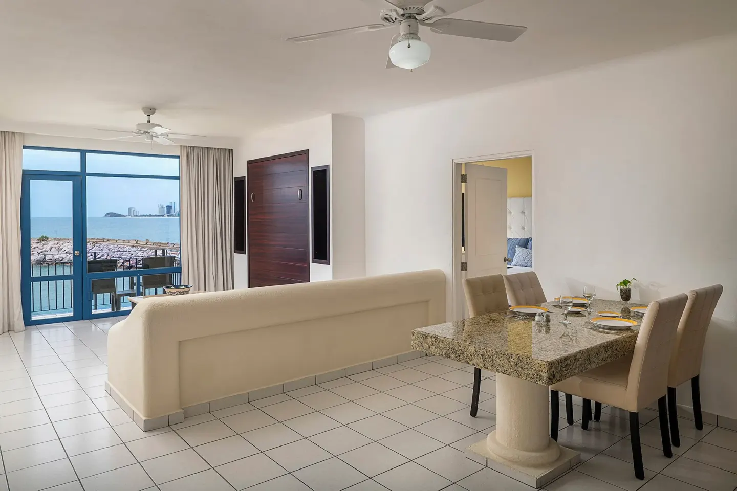 One Bedroom Suite dining table and living area at El Cid Marina Beach Hotel.