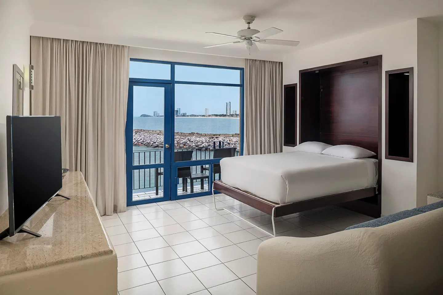 One Bedroom Suite wall bed and balcony view at El Cid Marina Beach Hotel.