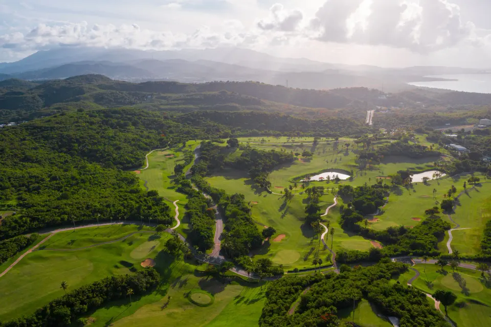 Aerial view of the golf course and green hills at El Conquistador Resort.