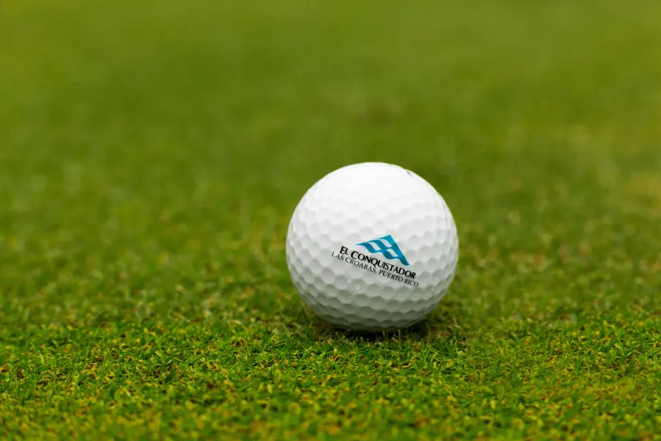 Golf ball on close-cut grass at El Conquistador Resort.