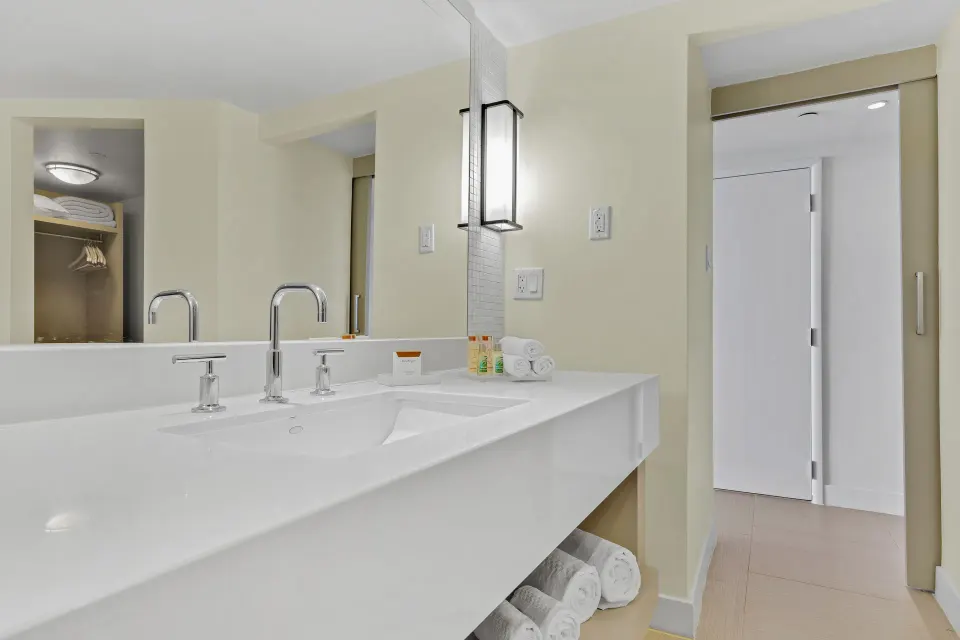 Guest bathroom with double vanity and mirrors at El Conquistador Resort.