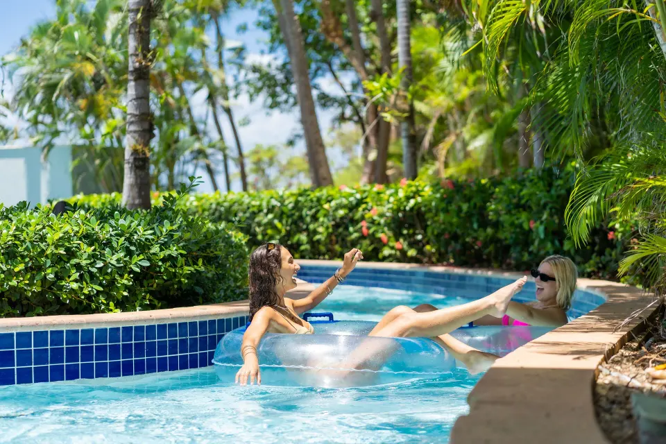 Two guests floating in a lazy river at El Conquistador Resort.