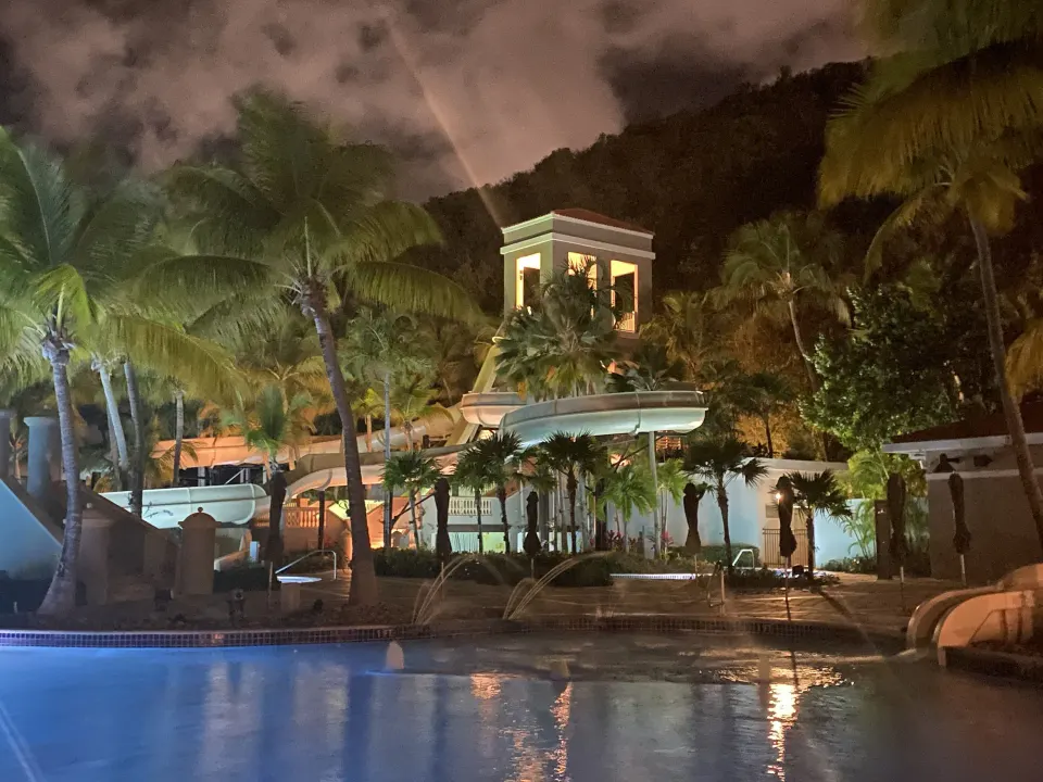 Illuminated pool area at night at El Conquistador Resort.