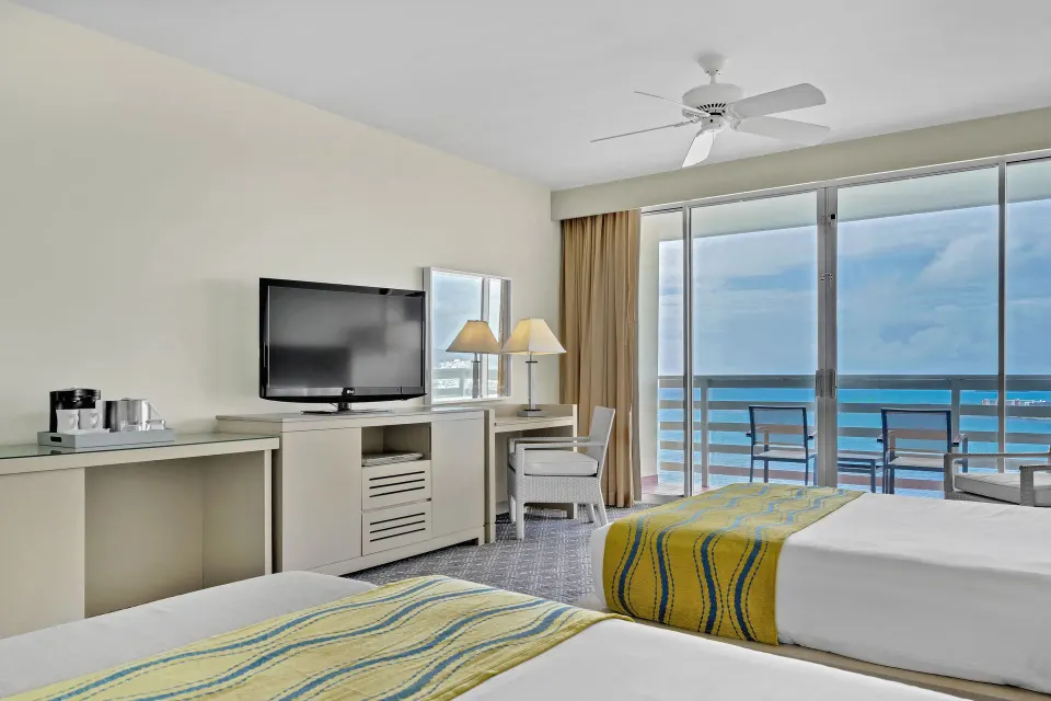 Two-bed ocean view guest room with balcony at El Conquistador Resort.