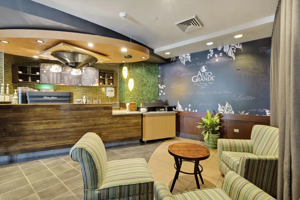 Coffee lounge with striped chairs and counter seating at El Conquistador Resort.