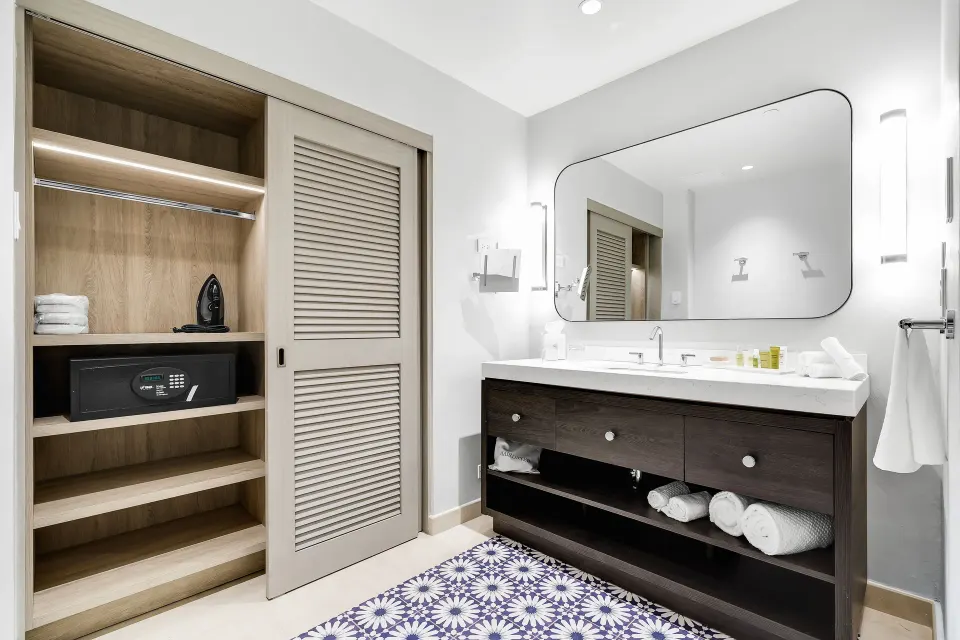 Bathroom vanity and open closet in a Deluxe Marina View Room at El Conquistador Resort.