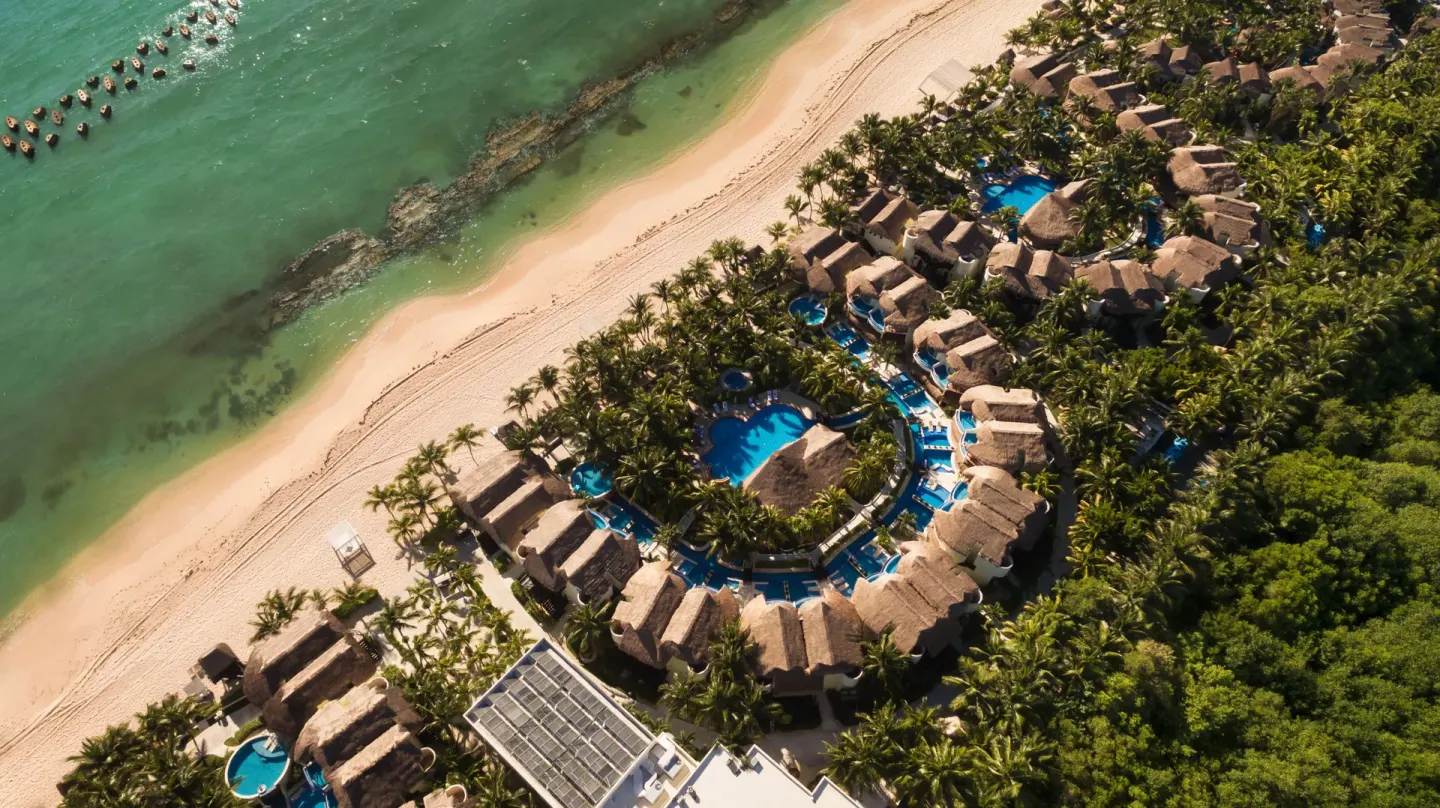 Aerial view of beachfront casitas and pools at El Dorado Casitas Royale.