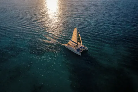 Catamaran sailing on sunlit turquoise water near El Dorado Casitas Royale.