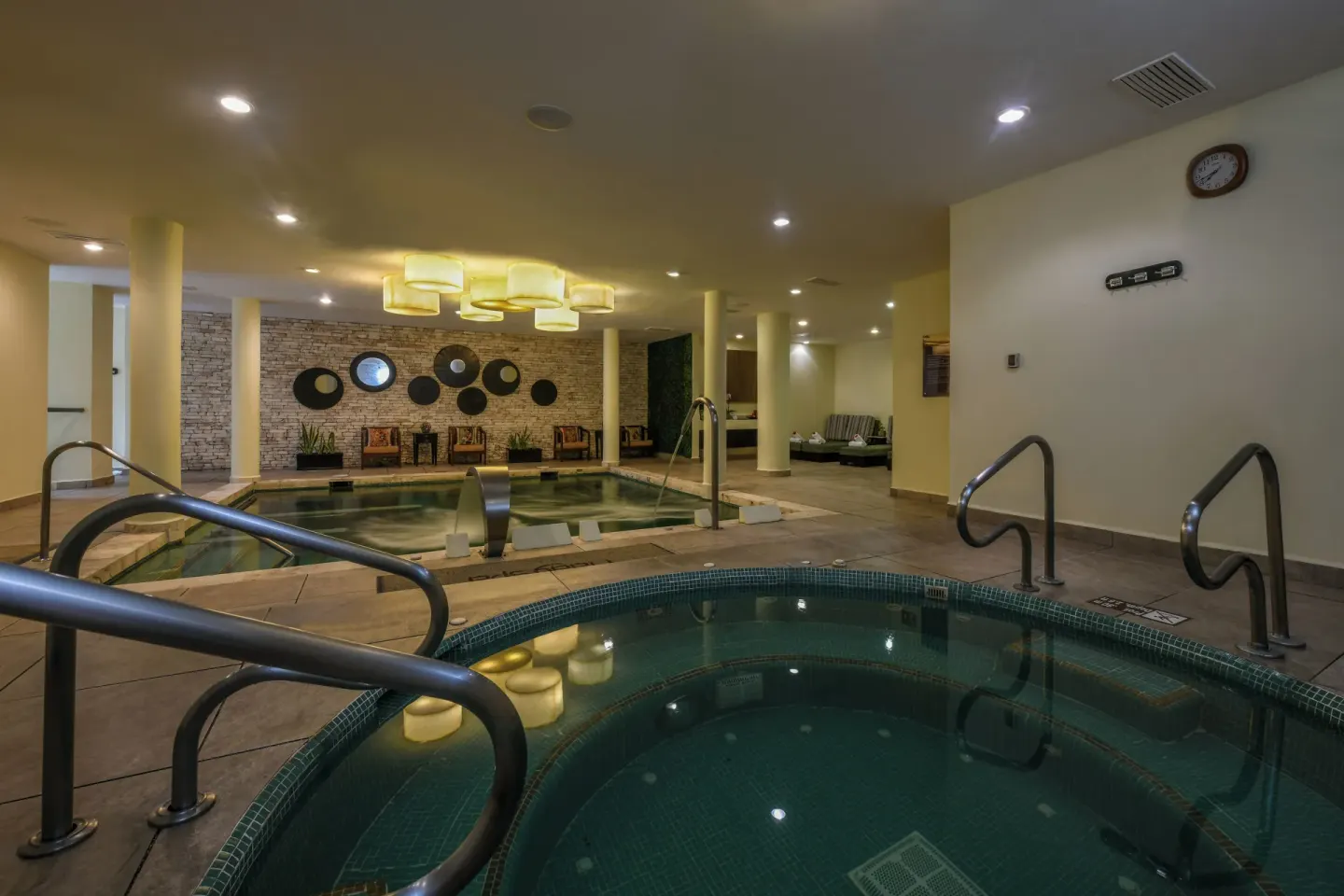 Indoor hydrotherapy pools with handrails and lounge seating at El Dorado Casitas Royale.