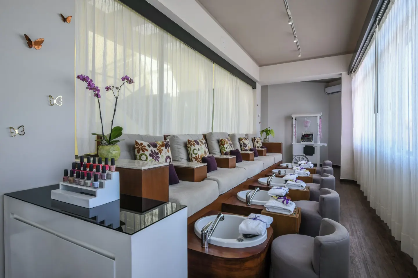 Nail salon with pedicure basins and polish displays at El Dorado Casitas Royale.