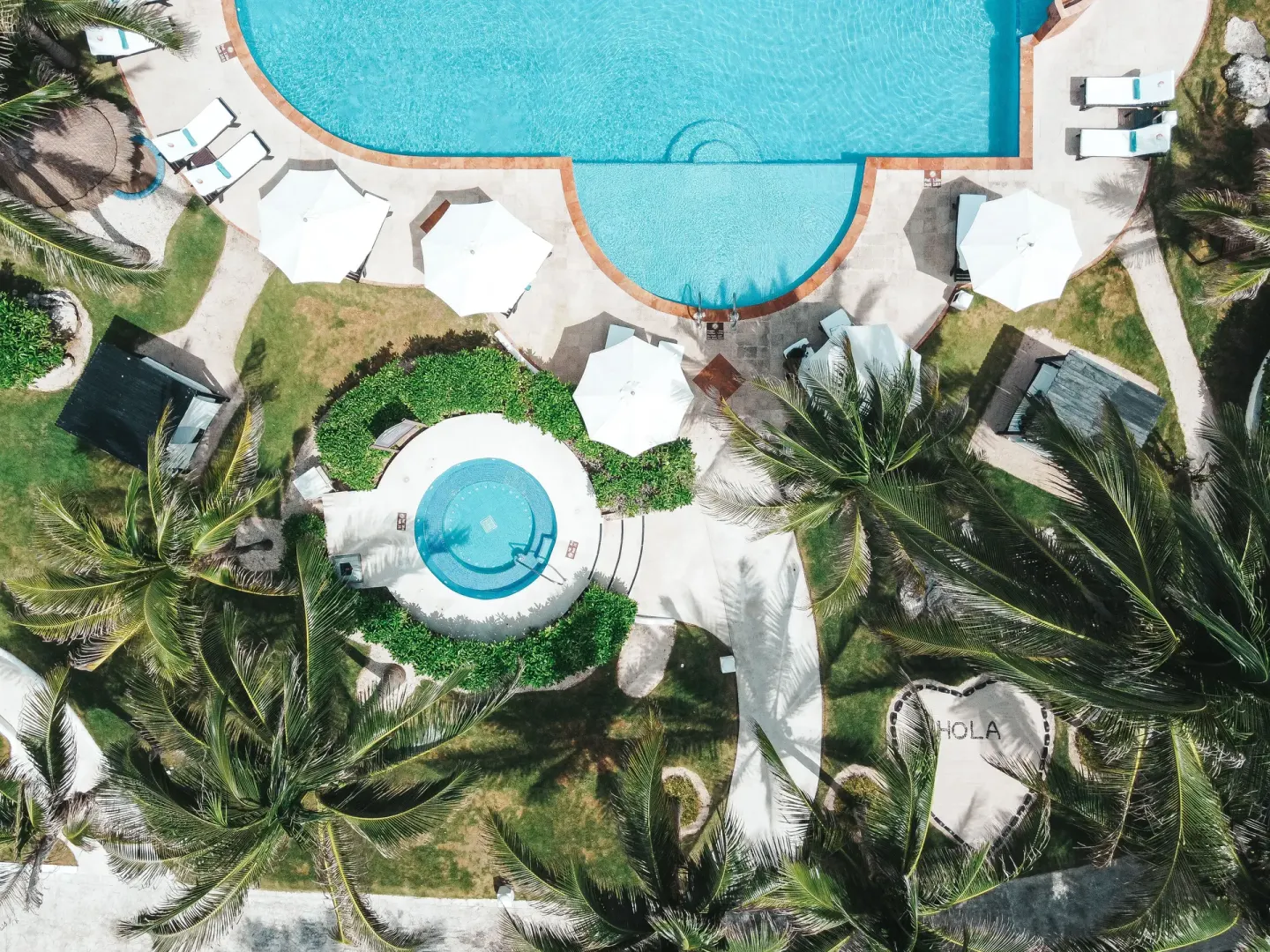 An overhead view shows a pool, whirlpool, umbrellas, and palms at El Dorado Casitas Royale.