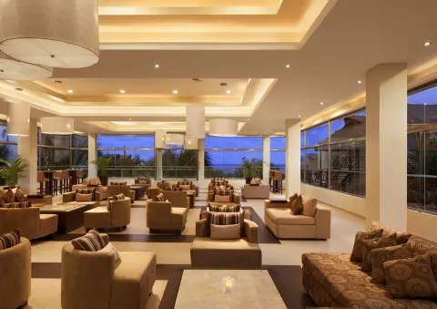 A spacious lounge with sofas and large windows at El Dorado Casitas Royale.