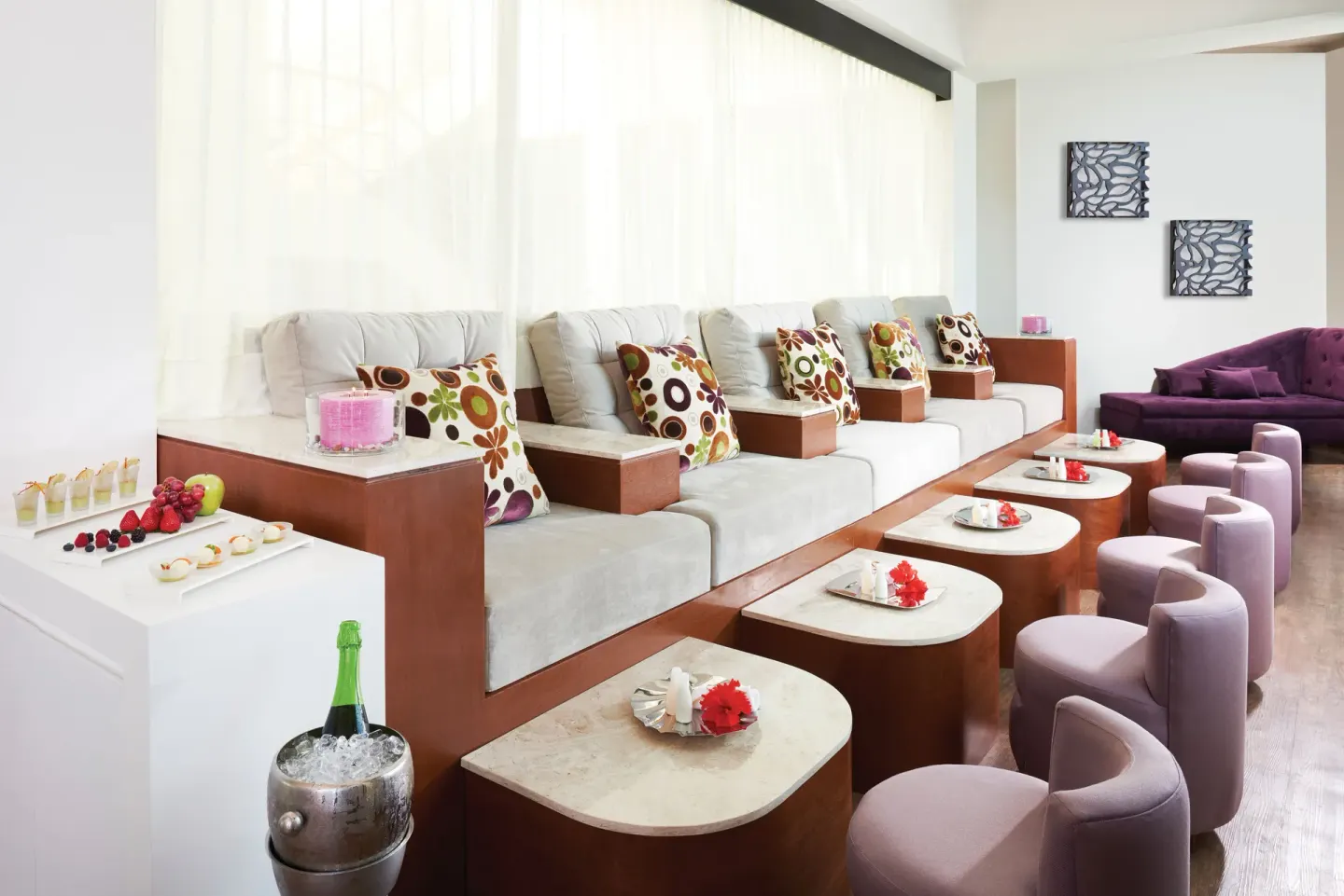 Spa lounge with cushioned seating, low tables, and refreshments at El Dorado Casitas Royale.