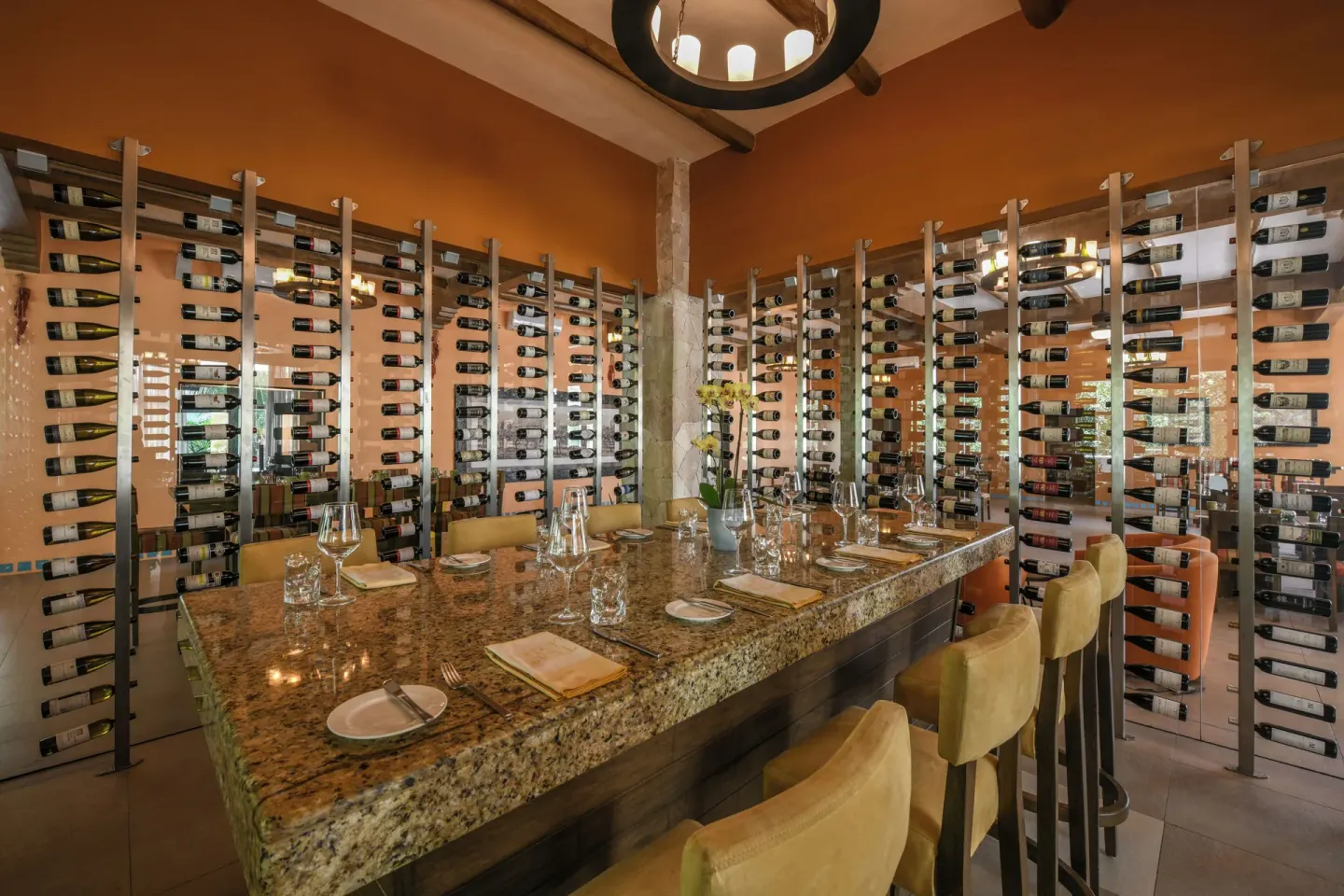 A private wine room with a granite table and wall racks at El Dorado Casitas Royale.