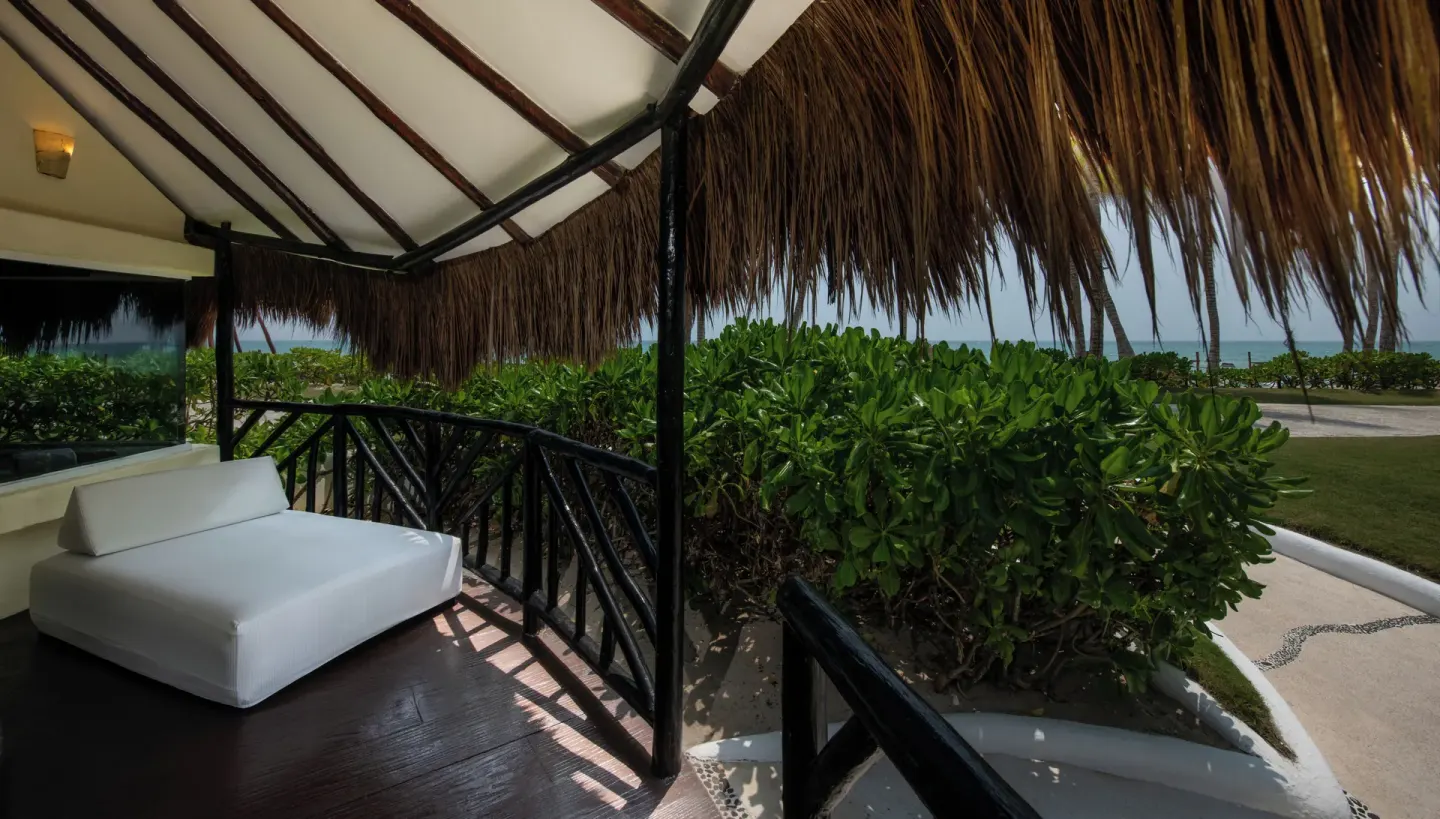 Beachfront Casita Suite terrace with daybed and ocean beyond at El Dorado Casitas Royale.