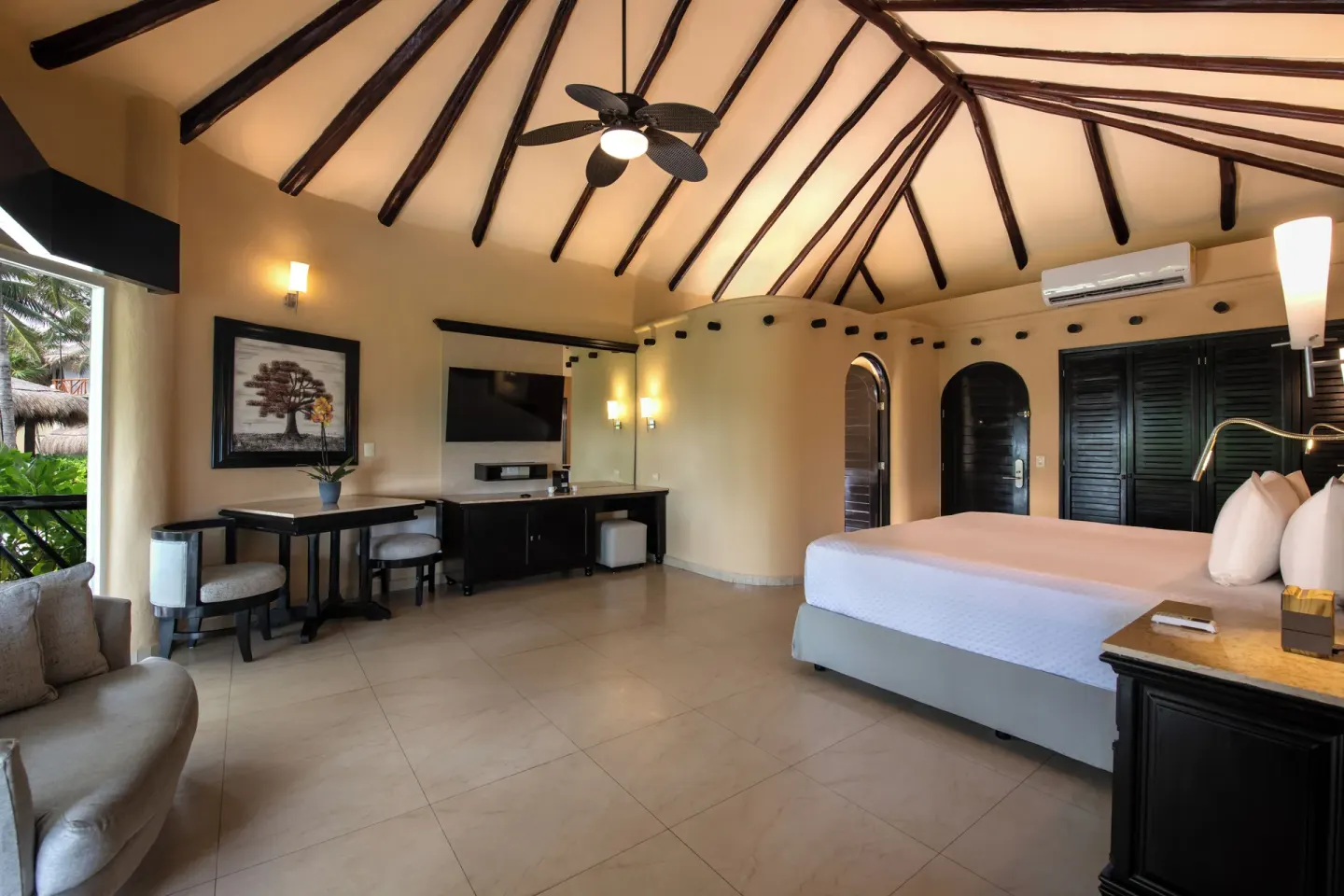 Casita Suite king bed, vaulted ceiling, and desk at El Dorado Casitas Royale.