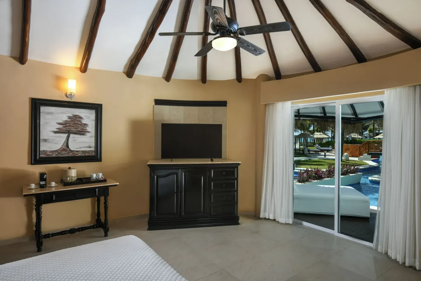 Royal Retreat Deluxe Swim Up Suite interior with TV and patio at El Dorado Casitas Royale.