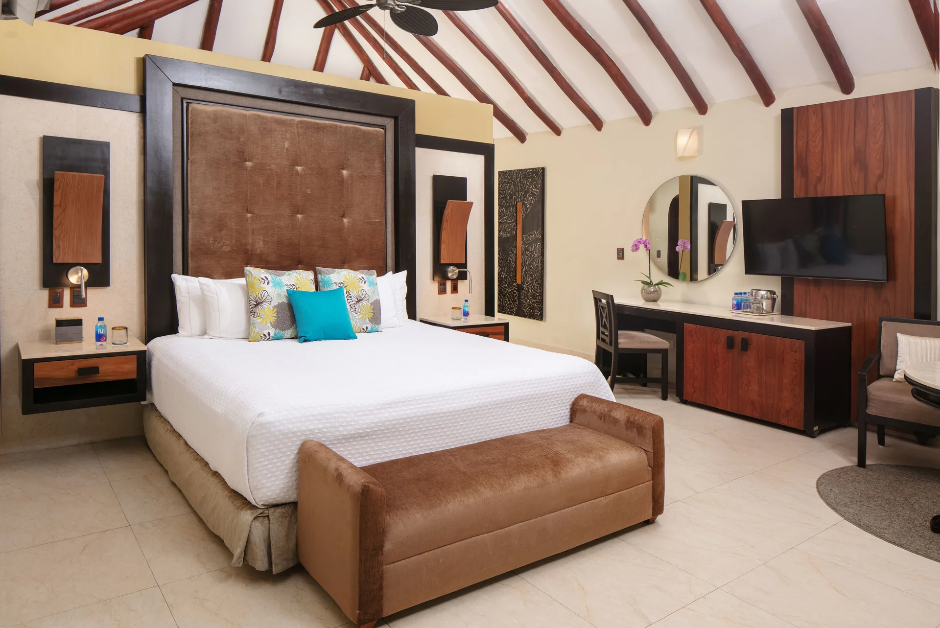 Swim Up Casita Suite bedroom with king bed and vaulted ceiling at El Dorado Casitas Royale.
