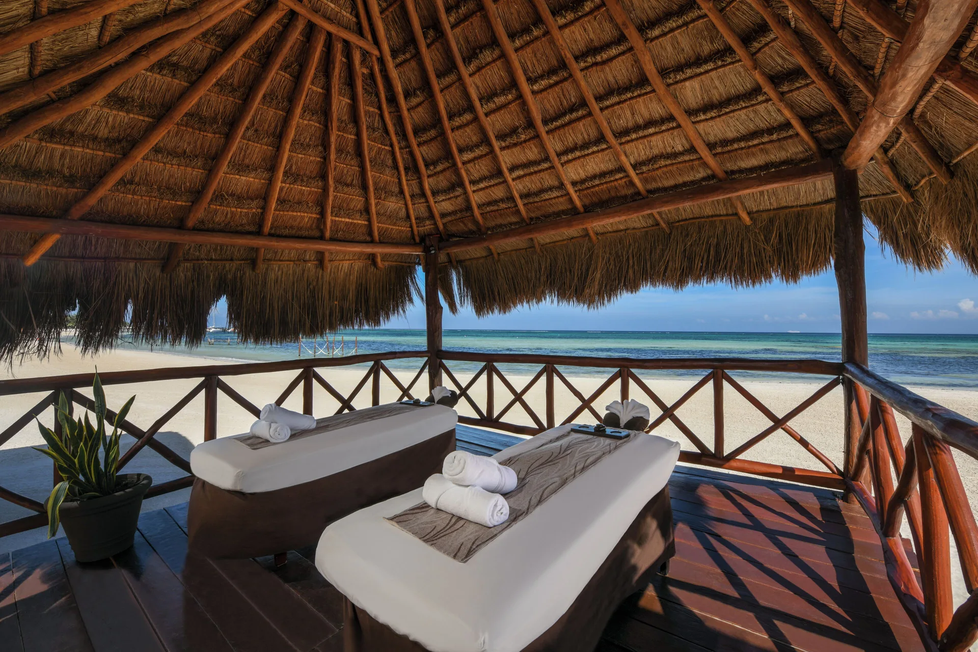 Beach massage palapa with two tables at El Dorado Maroma Cenote, Underground Expedition.