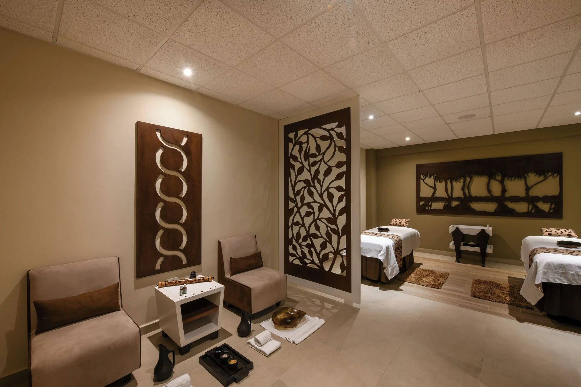 Spa treatment room with two massage tables at El Dorado Maroma Cenote, Underground Expedition.
