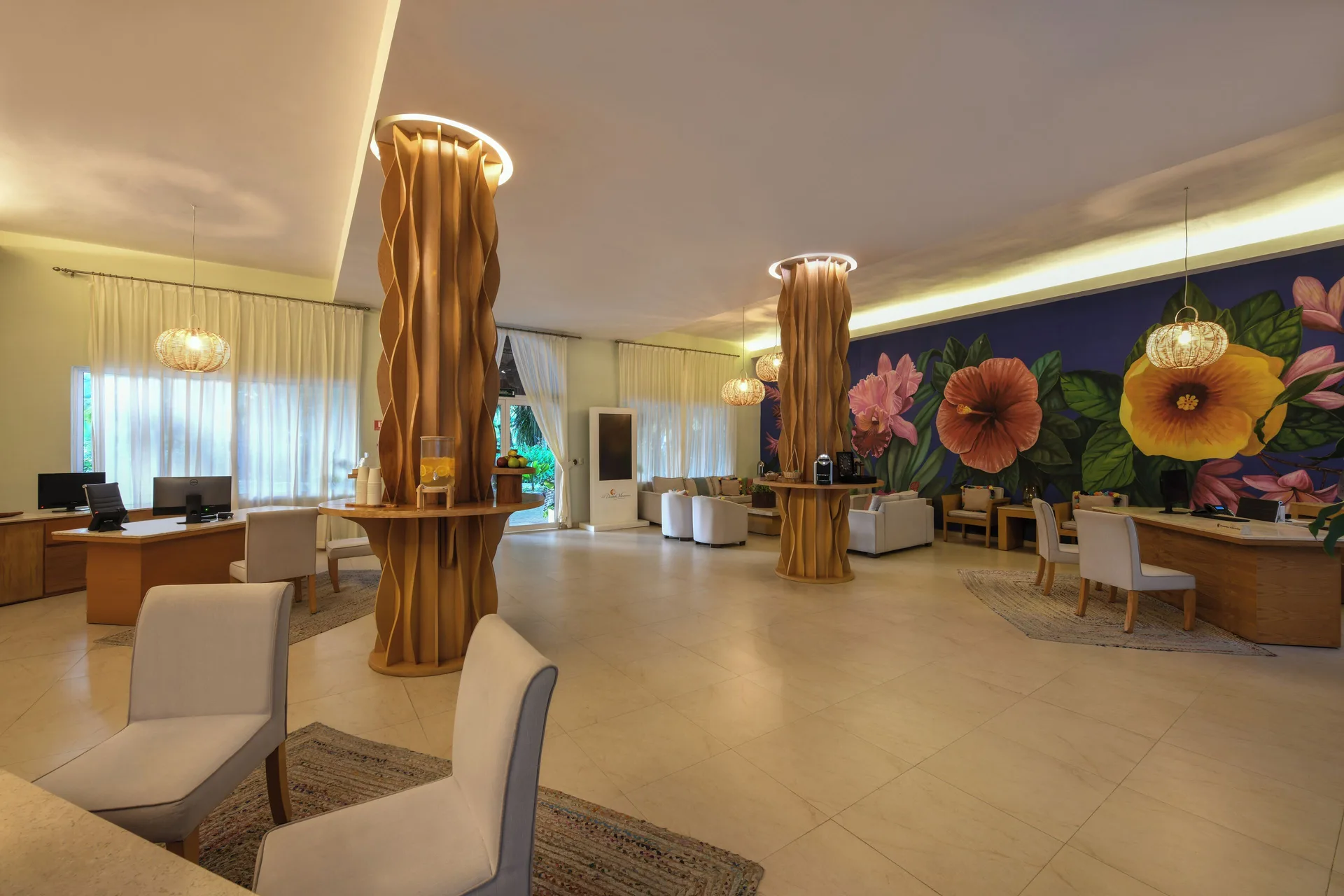 Lobby with flower mural and wood columns at El Dorado Maroma Cenote, Underground Expedition.