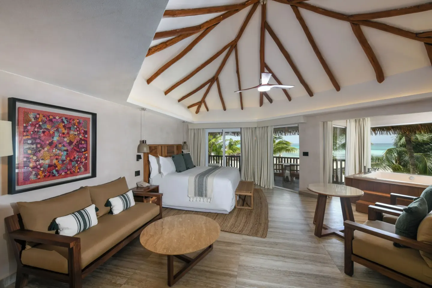 Oceanfront king bed guest room with vaulted wood ceiling at El Dorado Maroma Cenote, Underground Expedition.