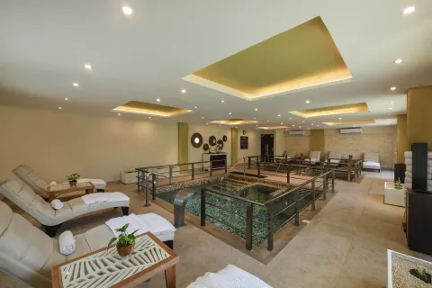 Spa hydrotherapy area with loungers at El Dorado Maroma Cenote, Underground Expedition.