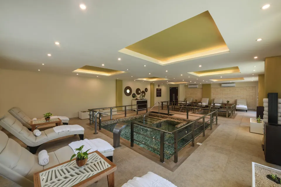 Spa hydrotherapy area with loungers at El Dorado Maroma Cenote, Underground Expedition.