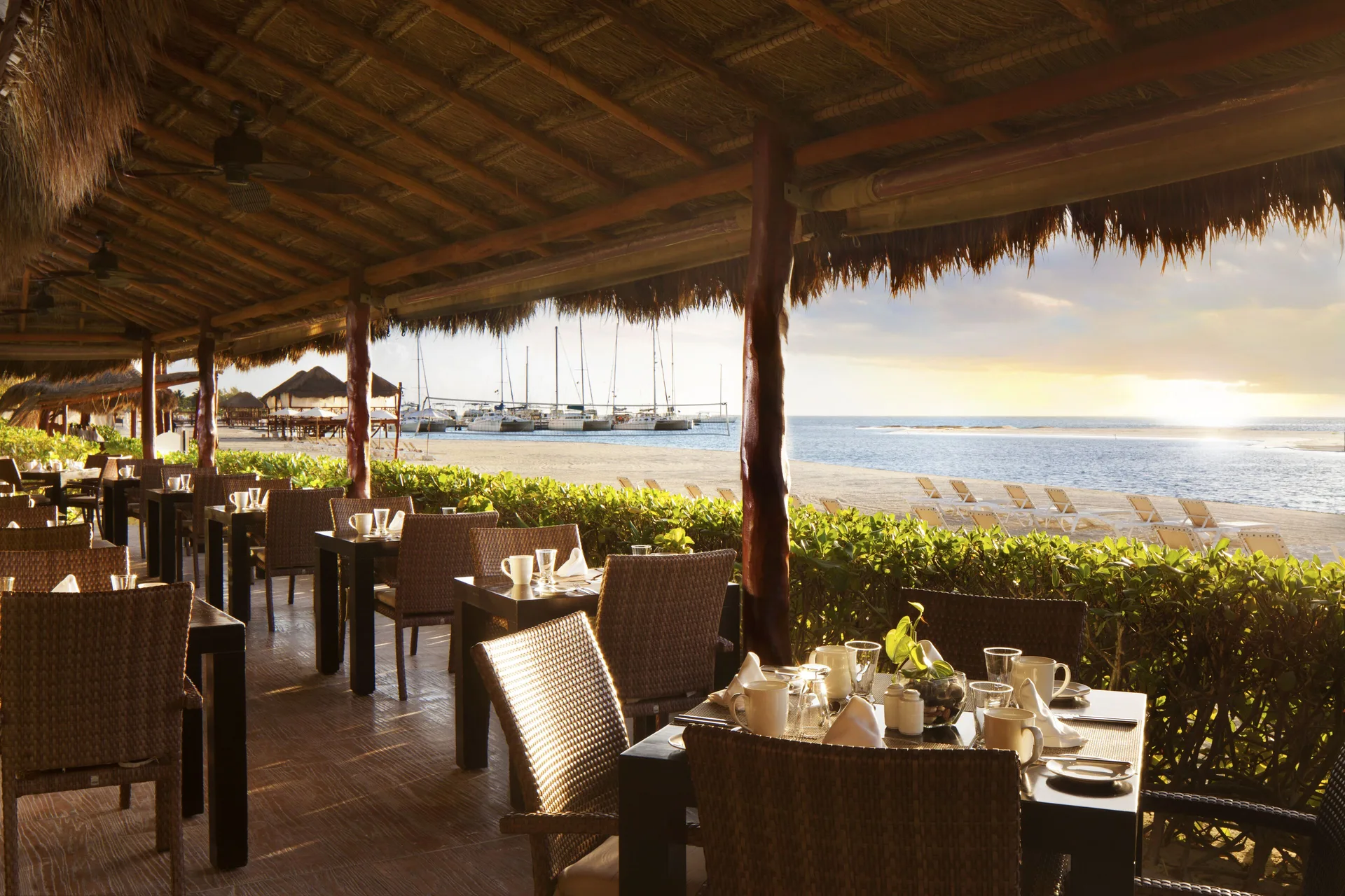 Beachfront covered dining terrace at El Dorado Maroma Cenote, Underground Expedition.
