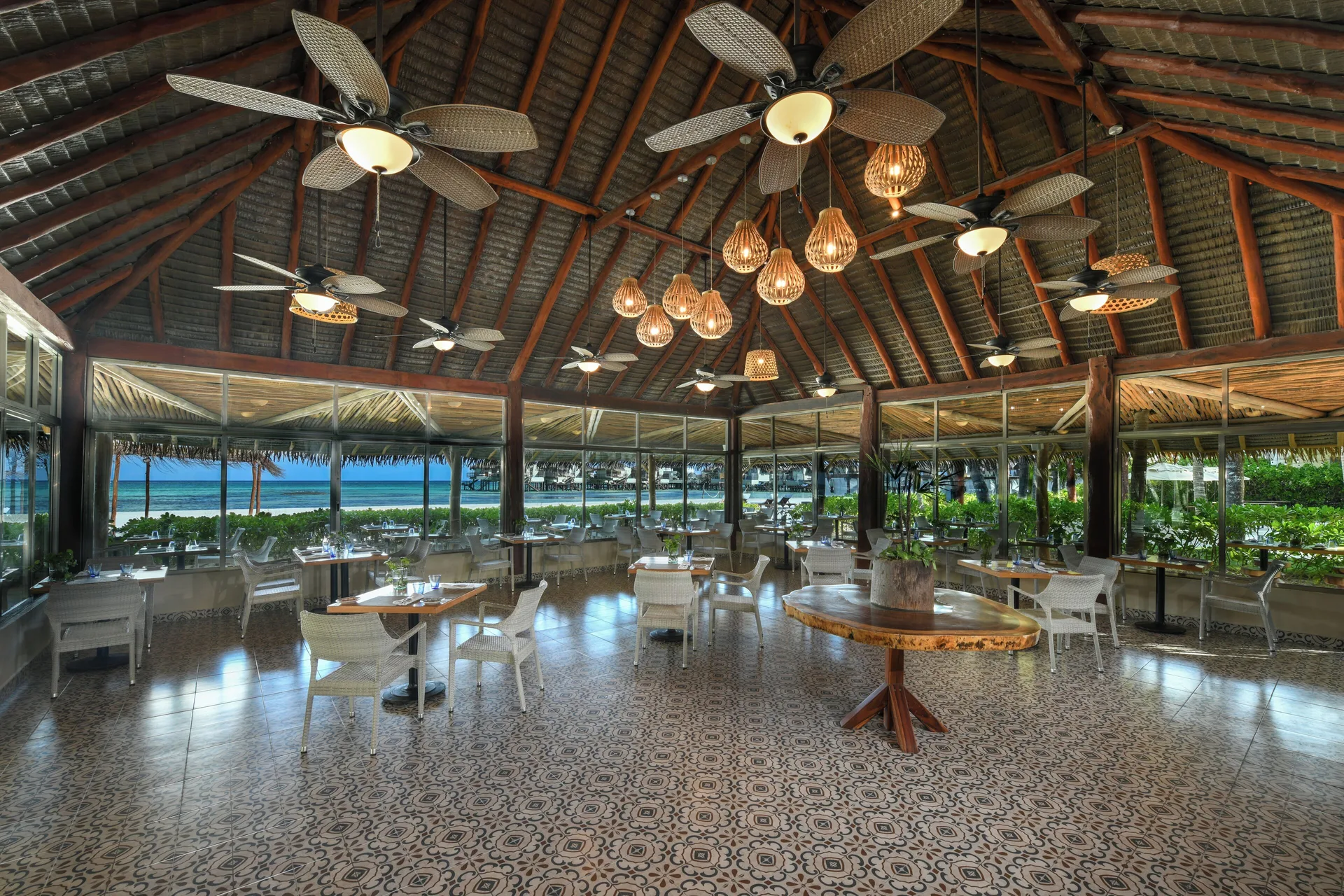 Thatched-roof restaurant with ocean views at El Dorado Maroma Cenote, Underground Expedition.