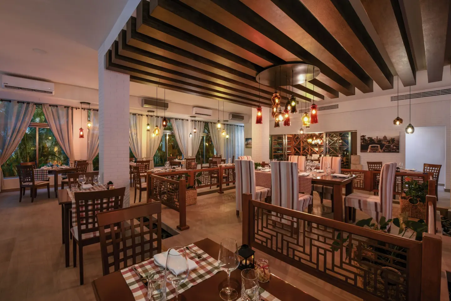 Italian-style dining room with set tables at El Dorado Maroma Cenote, Underground Expedition.