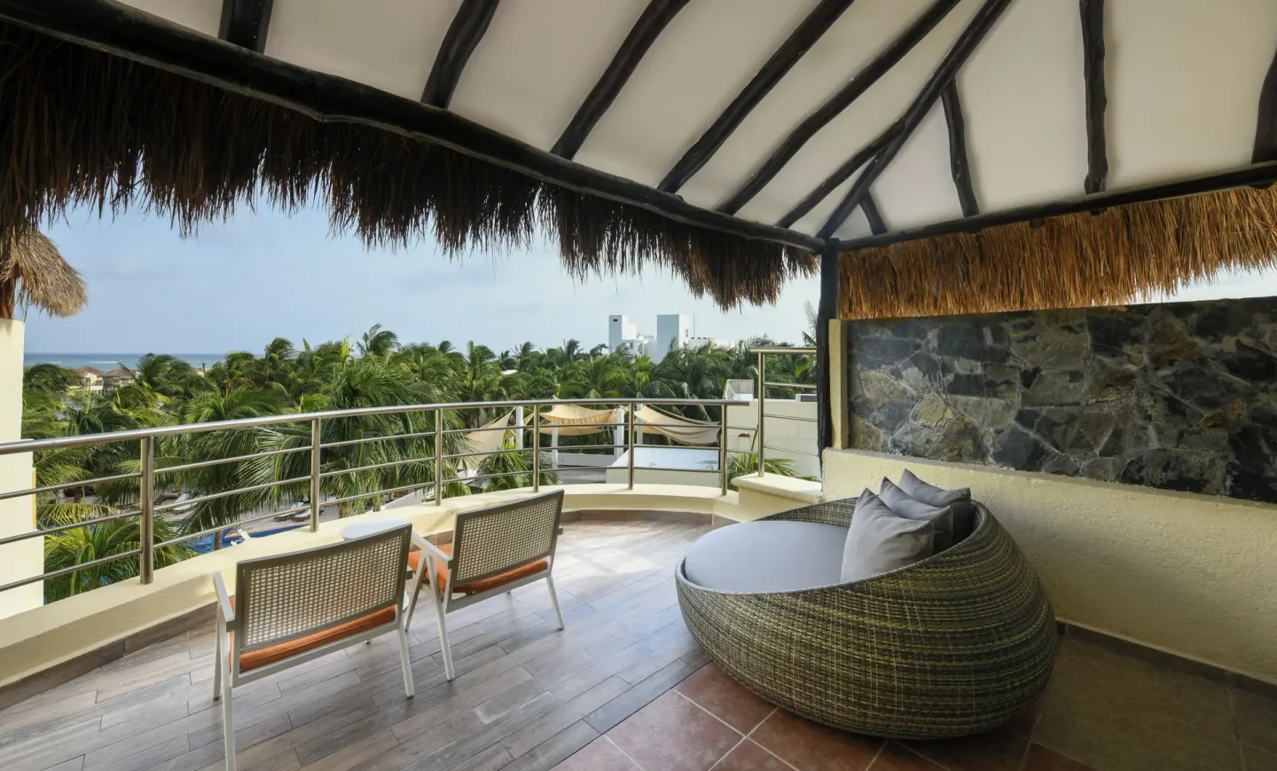 Honeymoon Suite terrace with loungers and palm views at El Dorado Maroma Cenote, Underground Expedition.