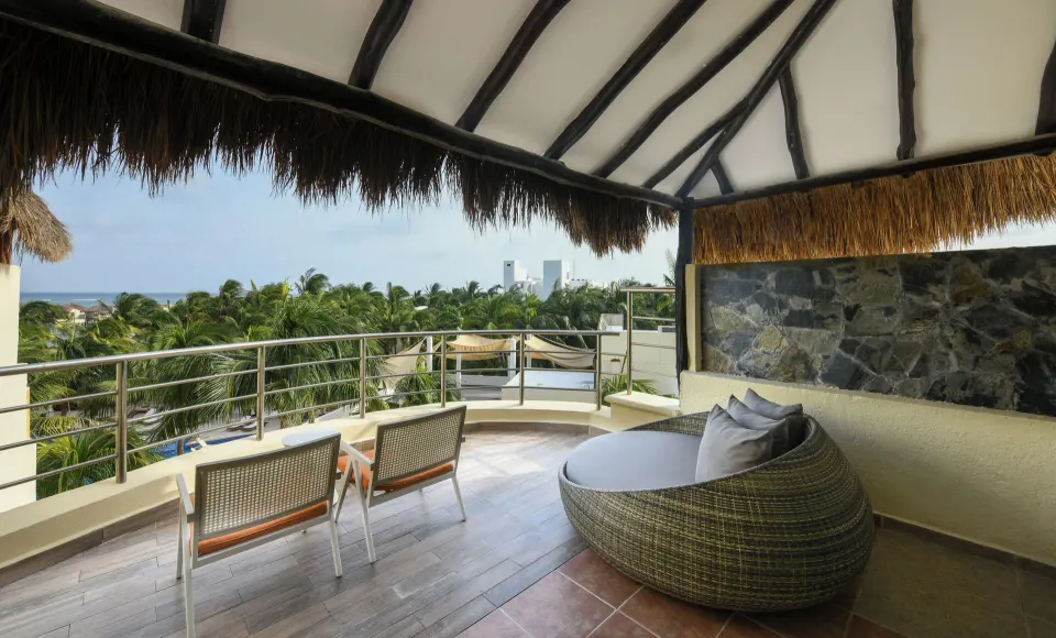 Honeymoon Suite terrace with loungers and palm views at El Dorado Maroma Cenote, Underground Expedition.