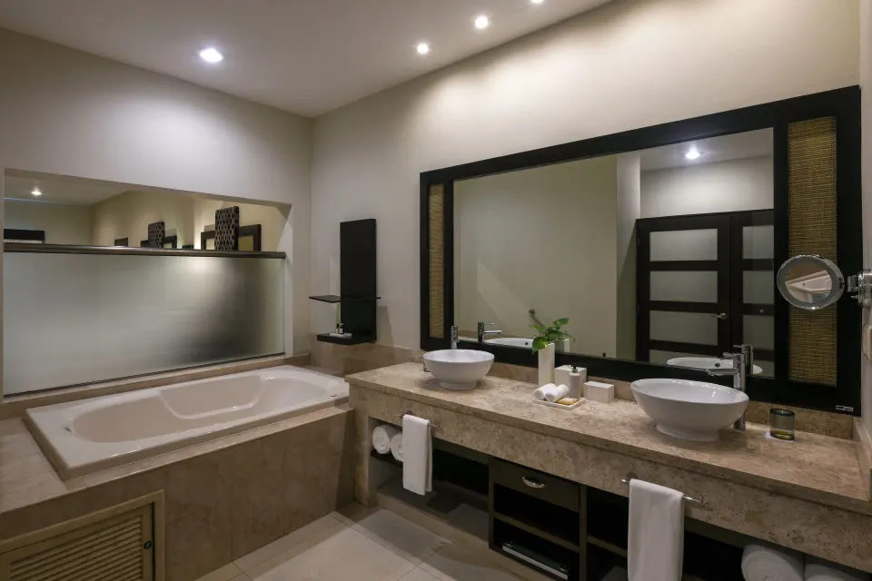 Junior Suite bathroom with soaking tub and double sinks at El Dorado Maroma Cenote, Underground Expedition.