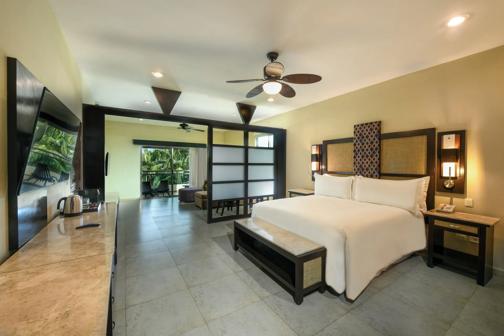 Junior Suite bedroom with king bed and balcony at El Dorado Maroma Cenote, Underground Expedition.