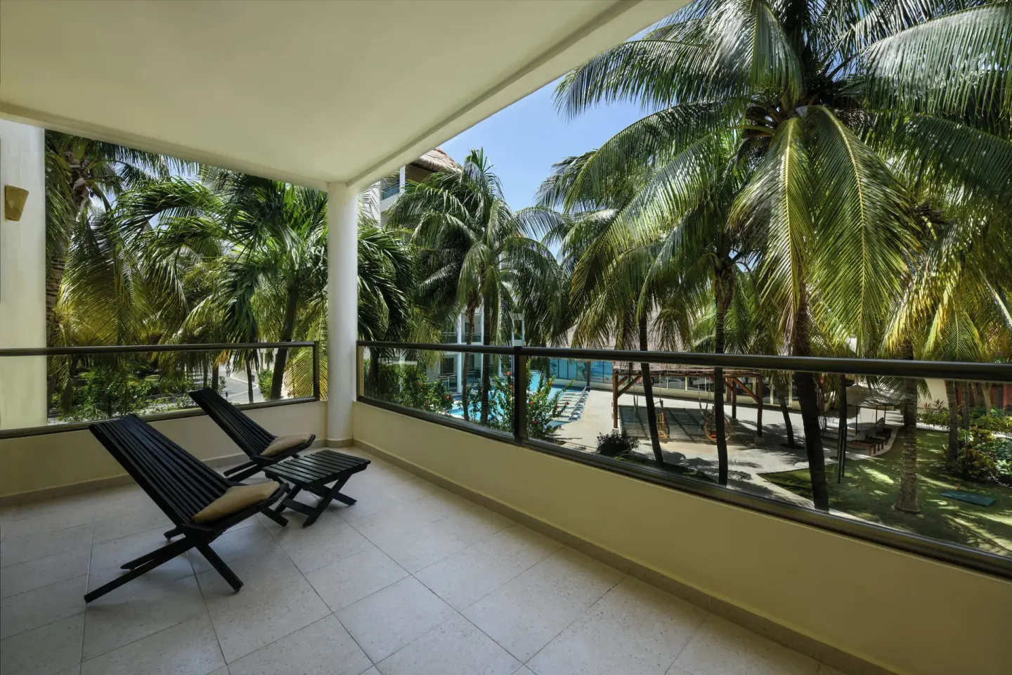 Royal Retreat studio balcony with lounge chairs at El Dorado Maroma Cenote, Underground Expedition.