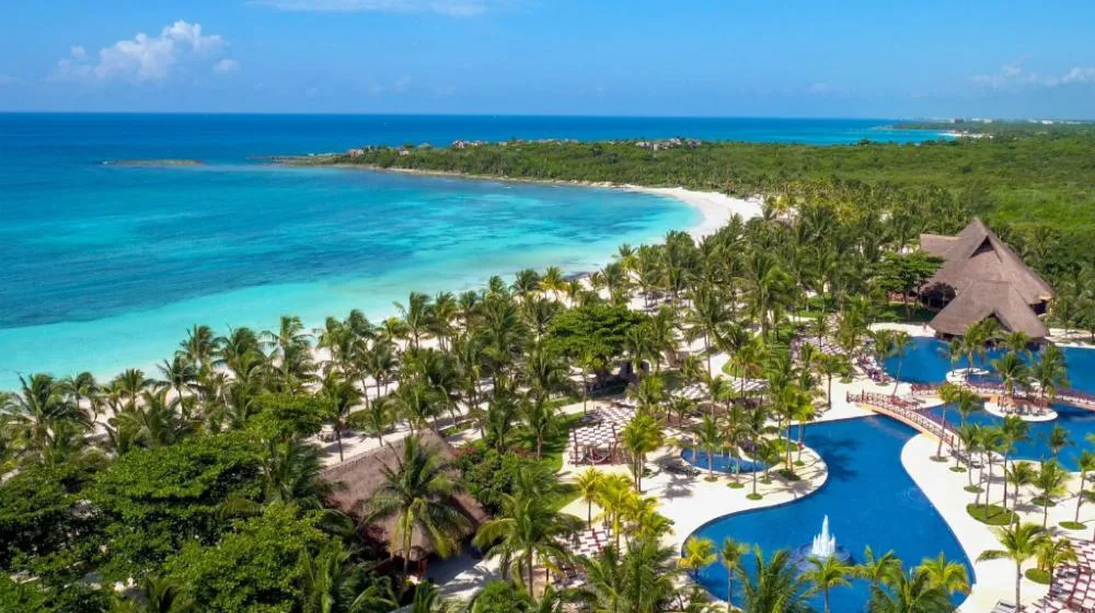 Barceló Maya Beach large beachfront all-inclusive resort with turquoise water and wide sandy beach in Xpu-Ha, Mexico.