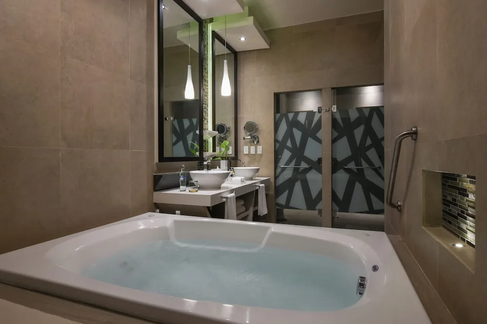 Guest bathroom with soaking tub and double vanity at El Dorado Seaside Suites