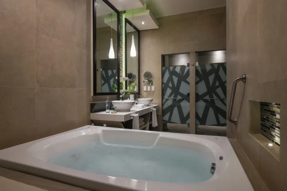 Bathroom with jetted tub and double sink vanity at El Dorado Seaside Suites