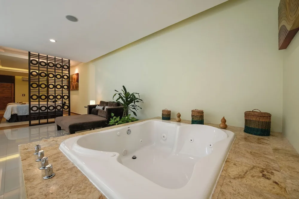 Suite interior showing large jetted tub and lounge area at El Dorado Seaside Suites