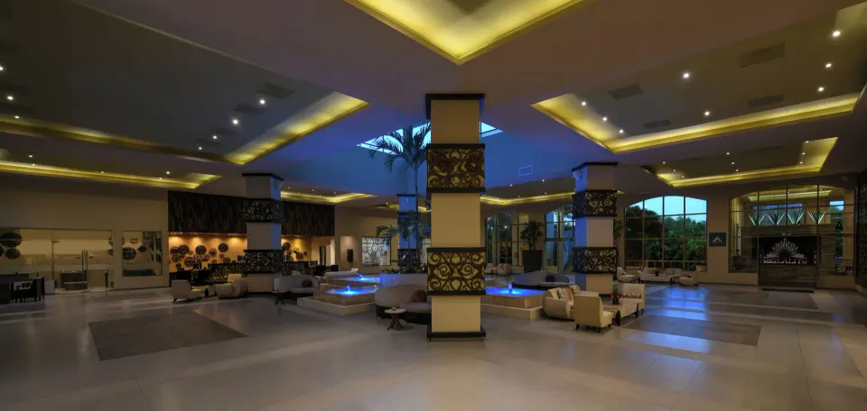 Spacious hotel lobby interior at El Dorado Seaside Suites with seating and decorative pillars