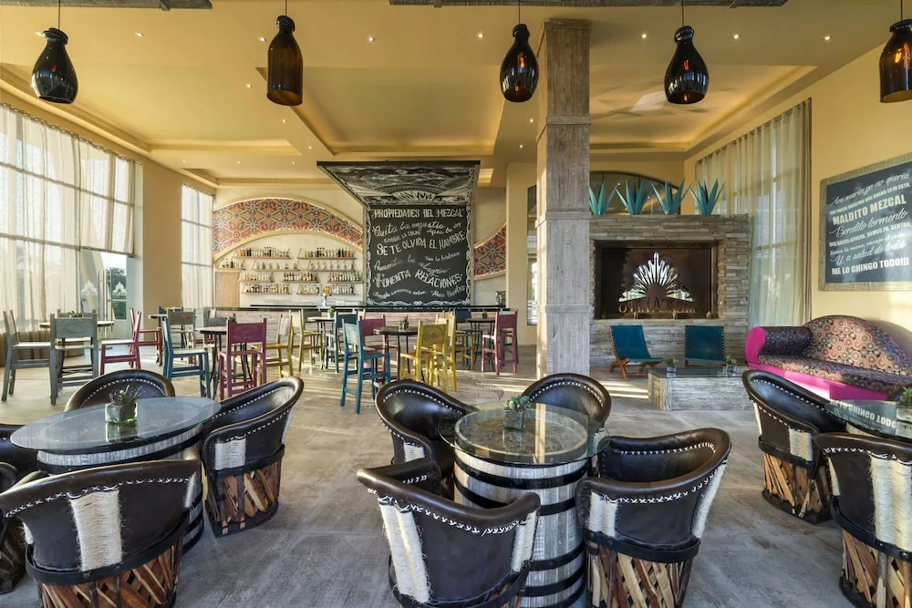 Bright casual dining room with mixed seating and chalkboard wall at El Dorado Seaside Suites.