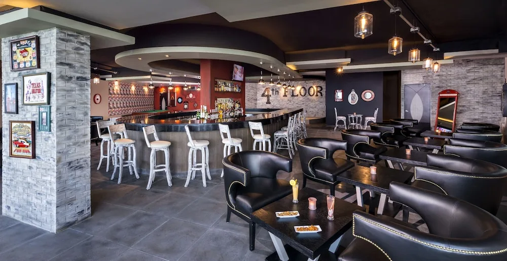 Contemporary lounge and bar area with leather seating at El Dorado Seaside Suites.