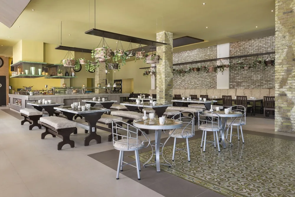 Bright open dining room with mixed seating at El Dorado Seaside Suites