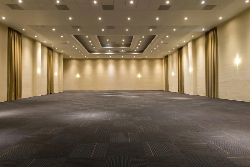 Large empty ballroom event space with recessed lighting at El Dorado Seaside Suites.
