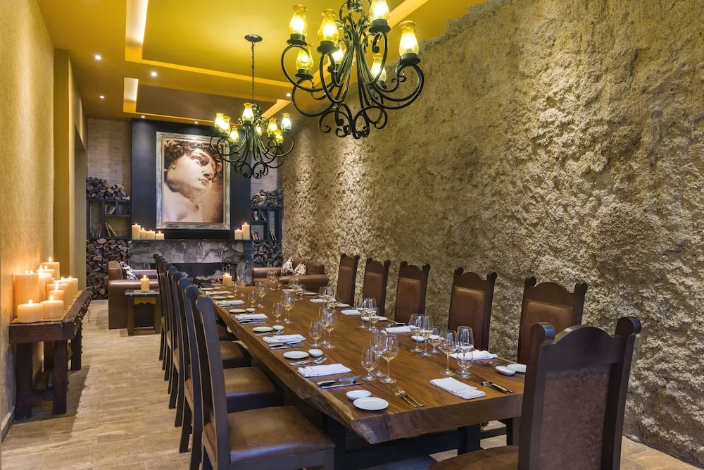 Private stone-walled dining room with long table at El Dorado Seaside Suites