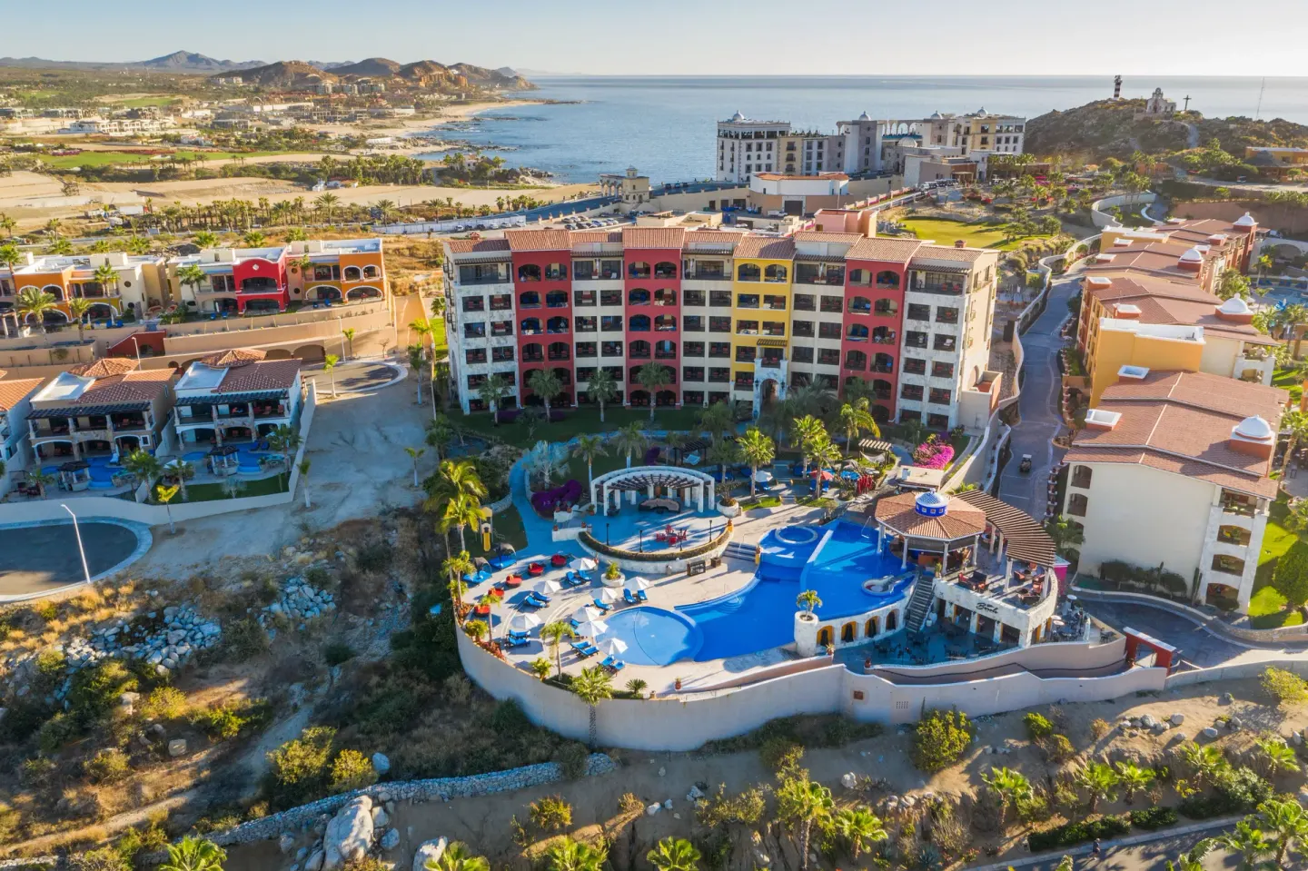 Aerial view of resort buildings, pools, and coastline at El Encanto at Hacienda Encantada.