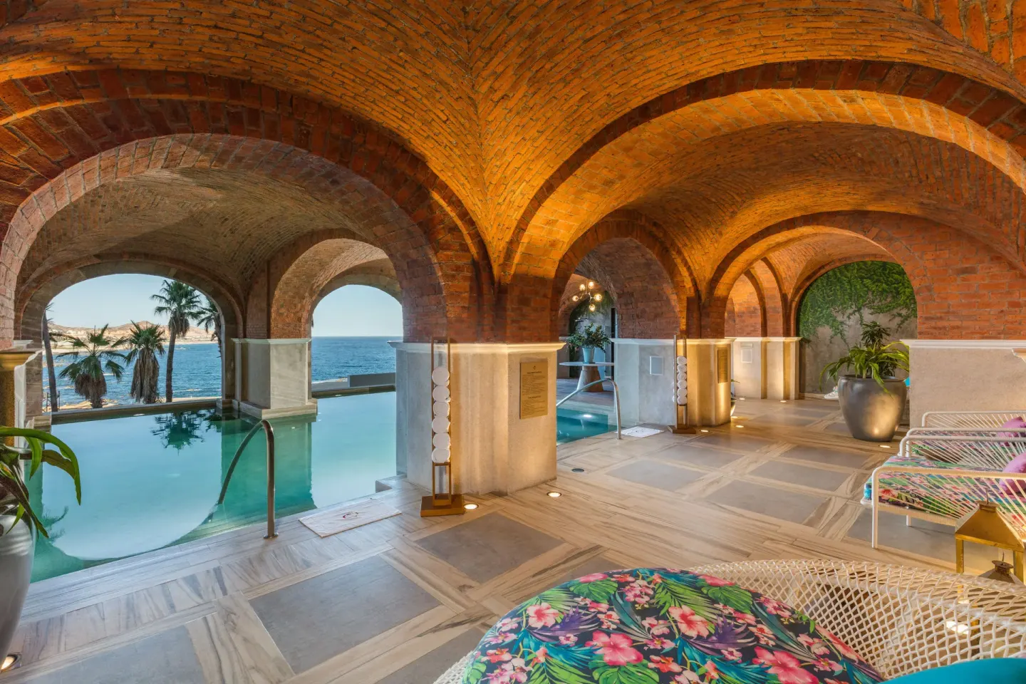 Arched indoor pool lounge with ocean view at El Encanto at Hacienda Encantada